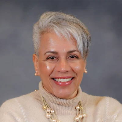 Front Office And Insurance Coordinator, Betsy, is seen smiling warmly at the viewer