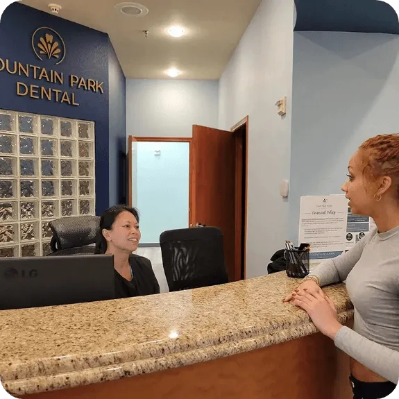 Dentist Flower Mound TX Front Desk Meeting With Patient HP Jeanny is at the front desk speaking with a patient