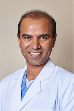Dentist Flower Mound TX Girish Chaudhari Headshot HP a photo of Dr. Girish Chaudhari D.D.S. looking at the camera and smiling