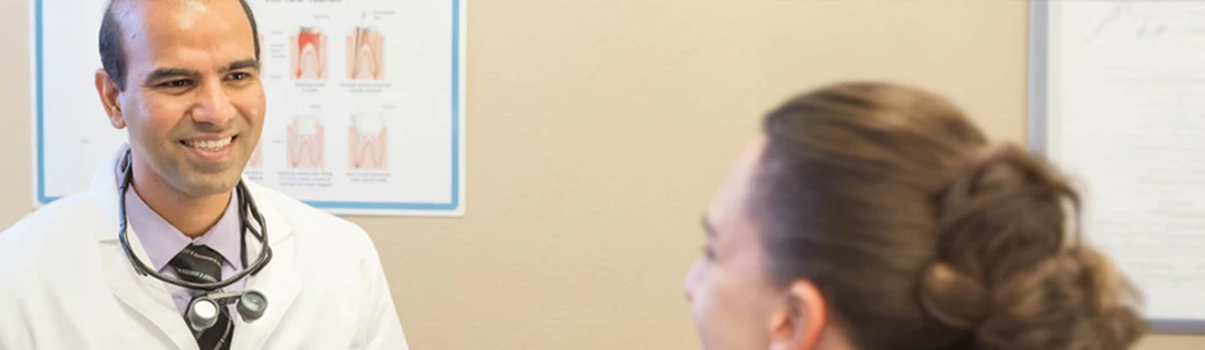 Dentist Flower Mound TX Girish Chaudhari Talking with Patient Services Hero Dr. Girish Chaudhari is pictured talking to a patient who is out of focus