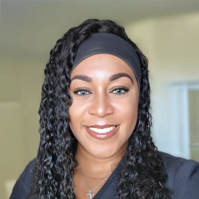 Patrice, a dental assistant at Fountain Park Dental, is seen smiling at the viewer