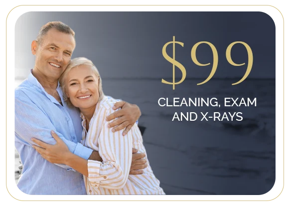 a middle aged couple is smiling on the beach embracing one another