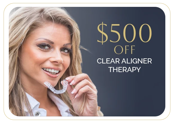 a woman with a clear aligner is smiling at the camera while holding her invisalign